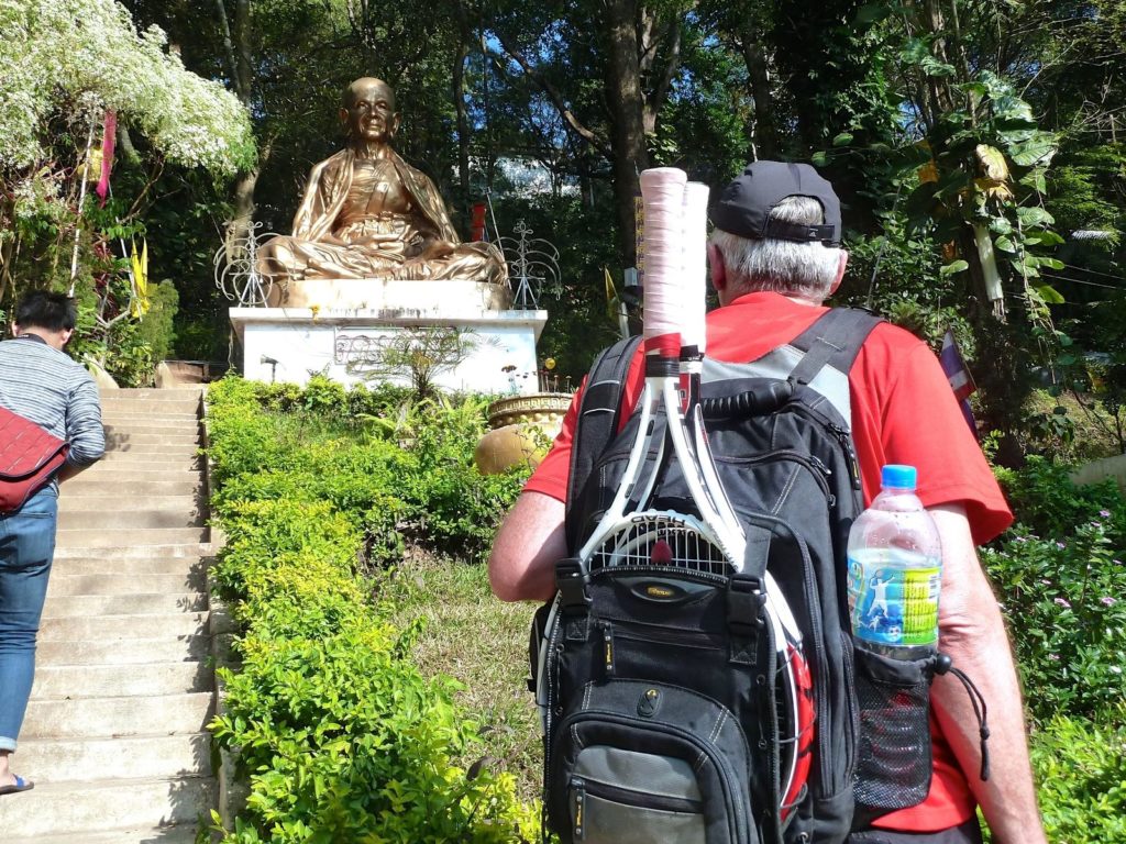 tennis-tourist-gold-buddha-statue-bill-looking-up-doi-suthep-above-Chiang-Mai-Thailand-teri-church