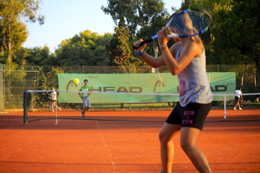 tennis-tourist-courtesy-kyllini-beach-resort-female-tennis-player-backhand-clay-court