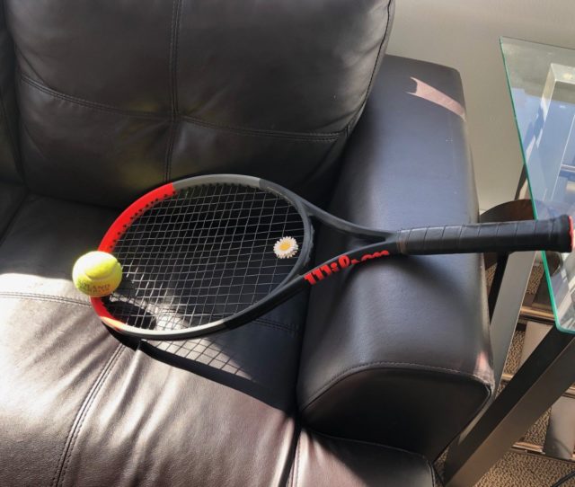 tennis racquet on sofa